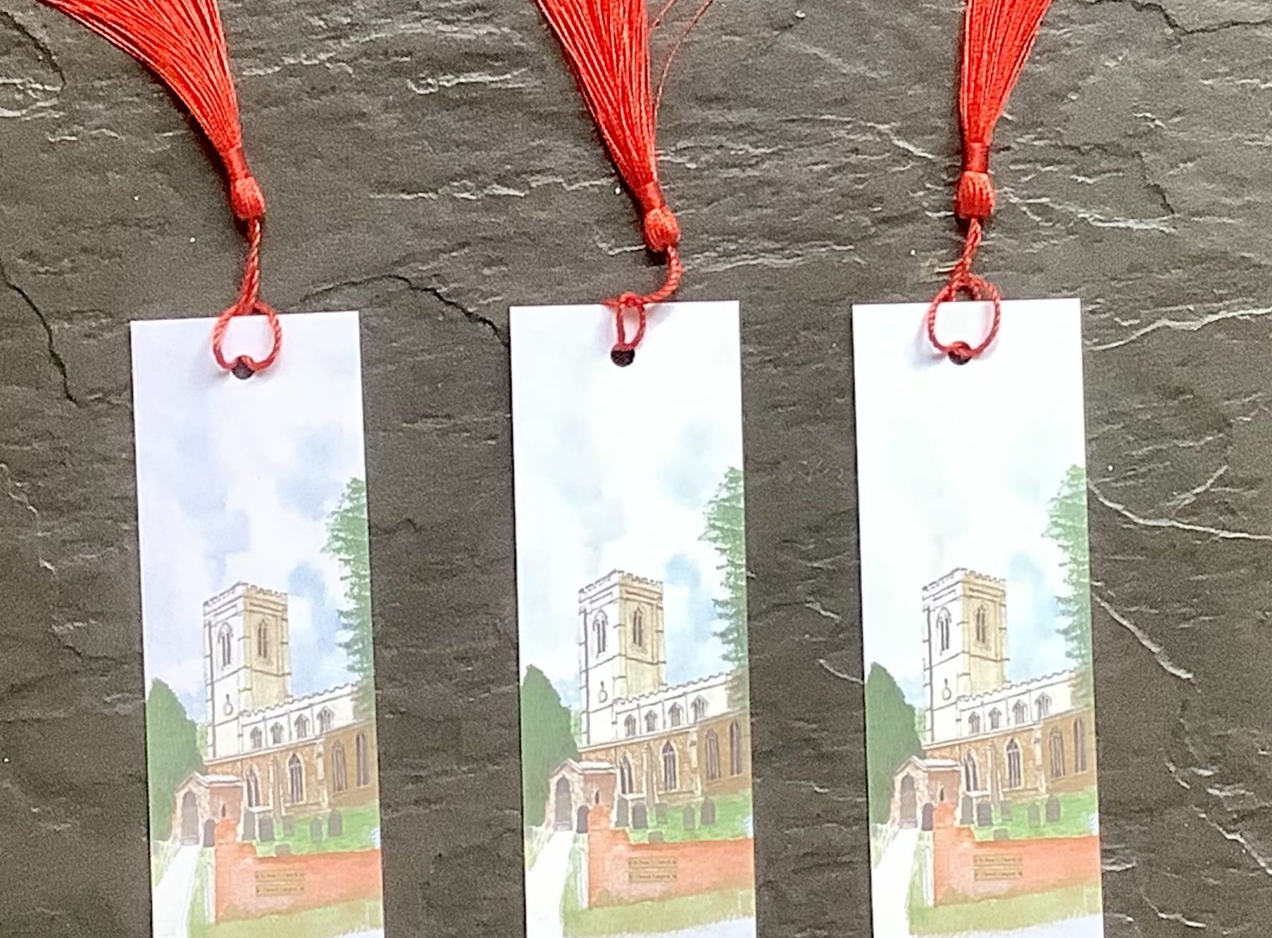 Three bookmarks, with smart red tassel