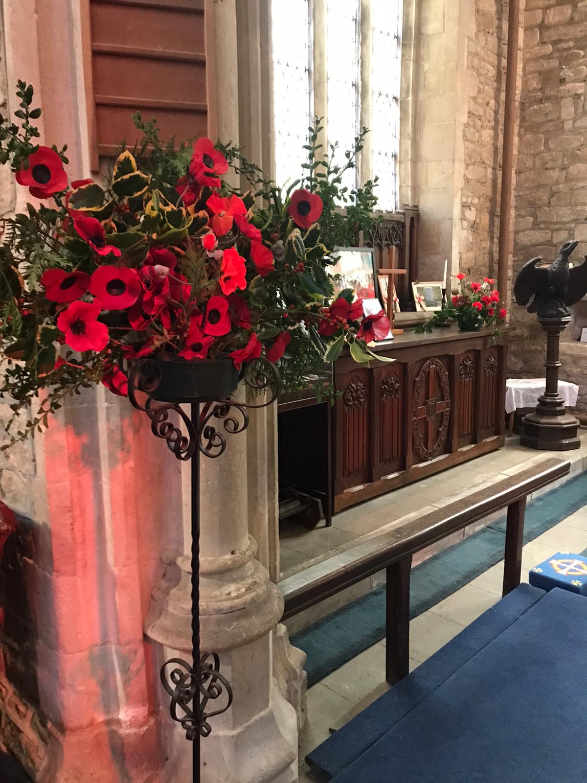 St Peter's Church, flowers to the side of the altar on Remembrance Sunday