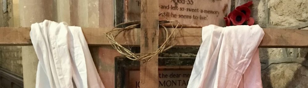 Easter cross in St Peter's Church - Header image which shows a section of a simple wooden cross draped in white cloth