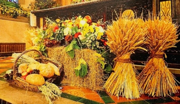 Image shows the altar decorated with wheat sheaves and fruit and veg